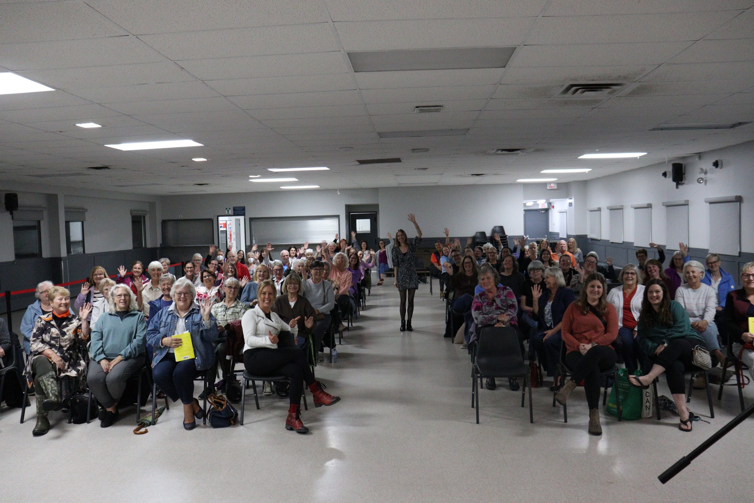 Bestselling author Nita Prose waves to the crowd alongside attendees at the Frank Kinnaird Community Centre in Russell.